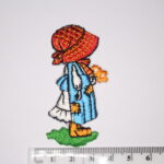 Girl with blue dress holding a bunch of flowers