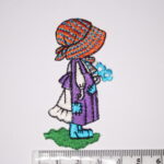 Girl with purple dress holding a bunch of flowers