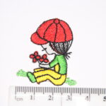 Girl sat with red hat holding a bunch of flowers